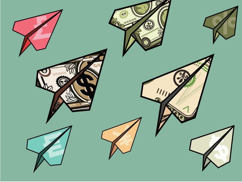 Paper airplanes made out of dollar bills and other currency