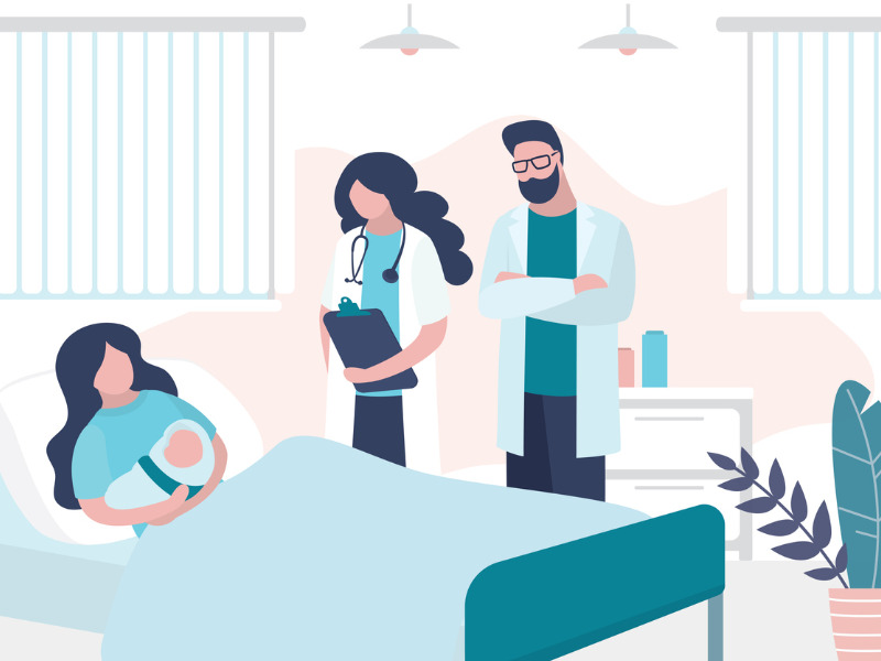 Woman lying on a bed, holding a newborn baby in a hospital room. A doctor and a man stand next to the bed.