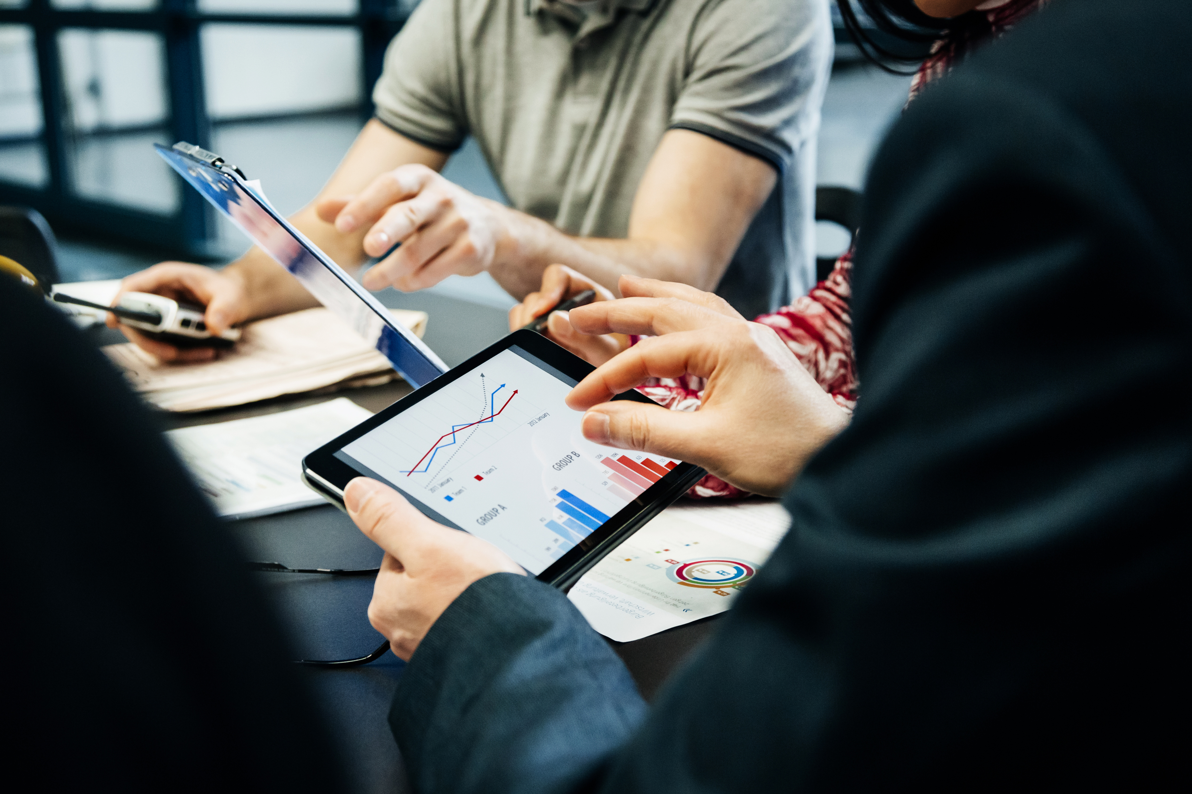 Business people holding tablet with graphs
