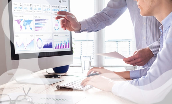 two people looking at data dashboards 