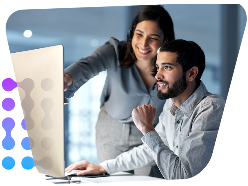 two people looking at computer monitor 