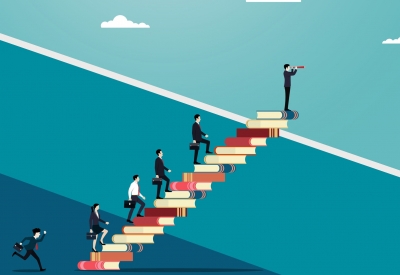 Team of business professionals with successful careers and education standing on books