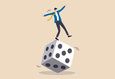 Person balancing on a large die that is still in movement