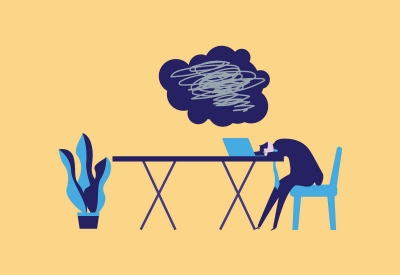 Businessperson frustrated with their head down on a desk