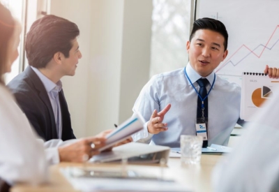 a healthcare finance team meeting in a conference room