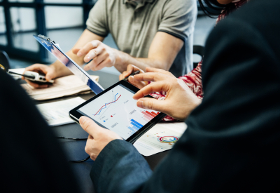 Business people holding tablet with graphs