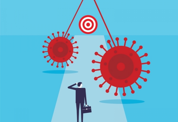 Business man walking along path towards target with swinging pendulums of COVID virus in the path