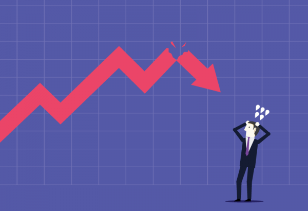 Businessman nervous over arrow on chart falling downward
