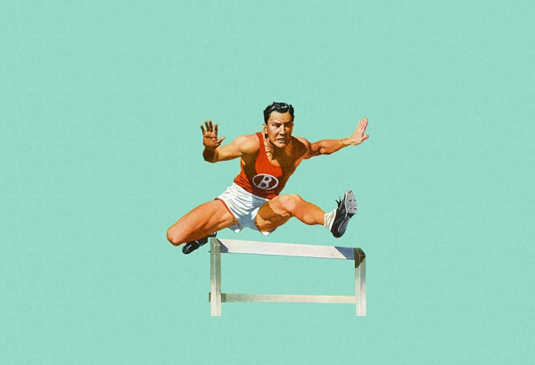 Man jumping over hurdle